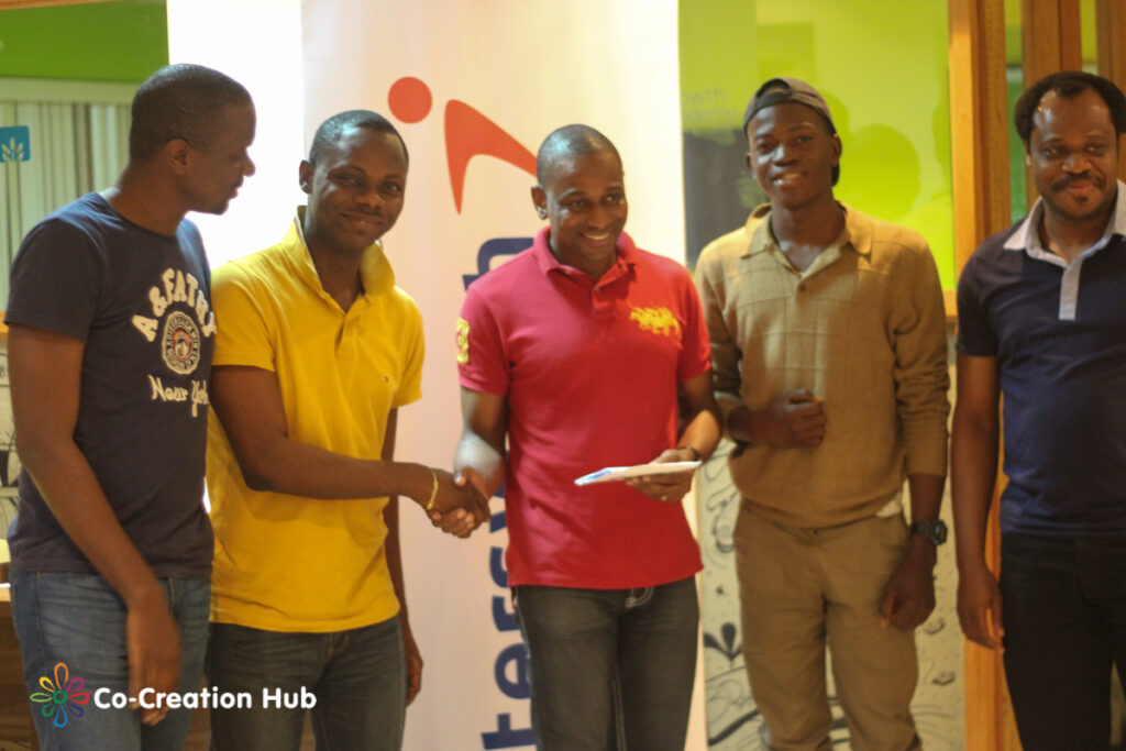 Team Sharply receiving their prize from Inalegwu Alogwu, Head, Products and Innovation, Interswitch