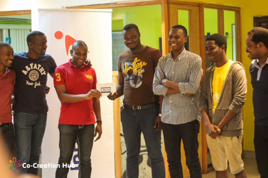 Team GoMyWay receiving their prize from Inalegwu Alogwu, Head, Products and Innovation, Interswitch 