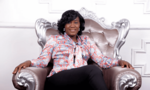 A woman sitting on a wide silver chair